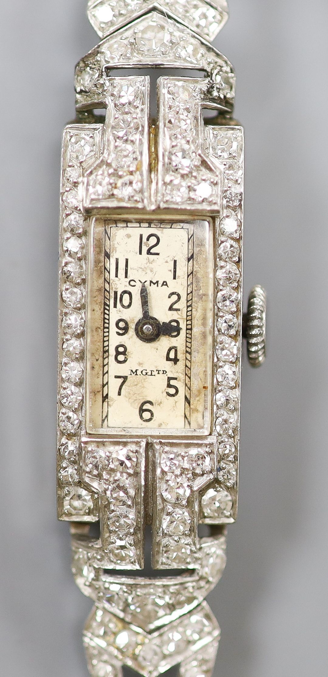 A white metal (stamped All platinum) and diamond set manual wind cocktail watch, on a 9ct white metal mesh bracelet, gross weight 21.6 grams.